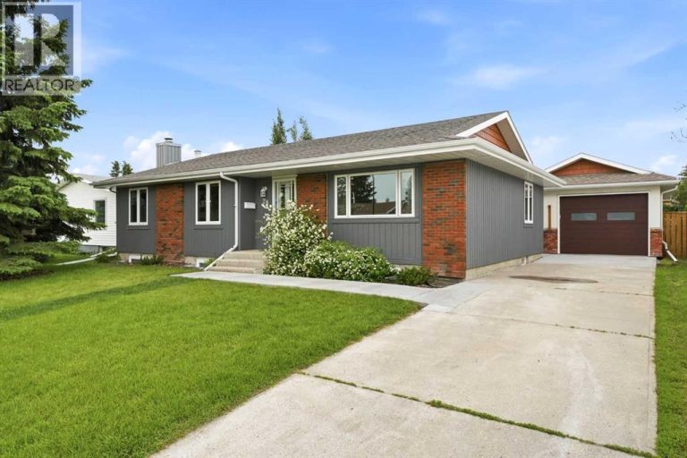 The home offers outstanding curb appeal with its oversized front yard, large mature evergreen, and recently refinished cedar siding