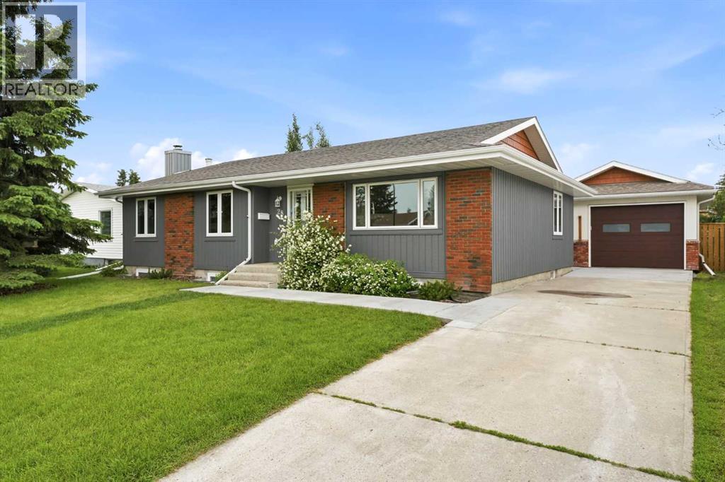 The home offers outstanding curb appeal with its oversized front yard, large mature evergreen, and recently refinished cedar siding