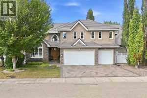 Exceptional curb appeal features a stone and stucco exterior, cement roof tiles, stamped concrete driveway and professional landscaping